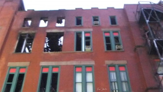 Brick Building with Red and Green Windows Trailer