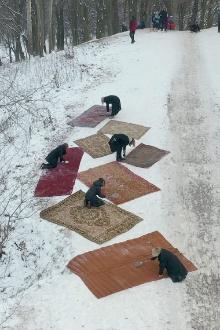 Women Knocking Out Carpets Trailer